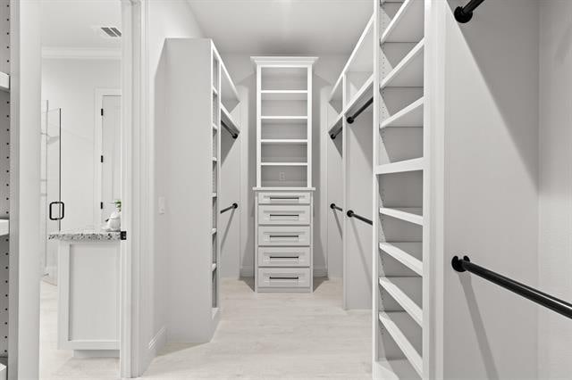 walk in closet featuring visible vents and light wood finished floors