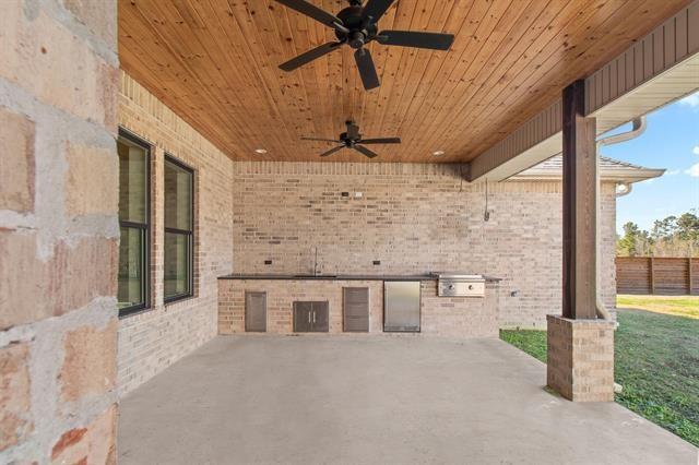 view of patio / terrace featuring a ceiling fan, a sink, fence, and area for grilling