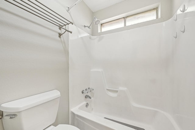 bathroom featuring shower / bathing tub combination and toilet