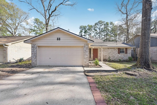 view of front of home with a garage, brick siding, and driveway