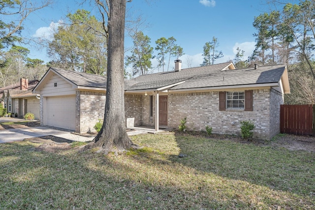 single story home with brick siding, an attached garage, fence, driveway, and a front lawn