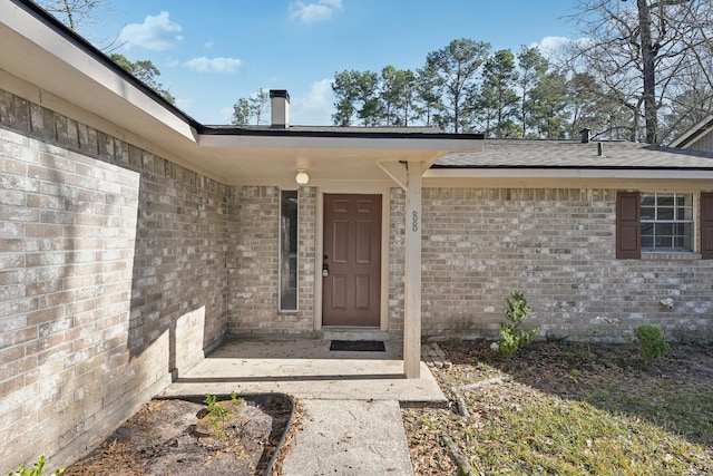 property entrance with brick siding