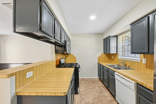 kitchen with a sink, baseboards, range with gas stovetop, dishwasher, and stainless steel microwave