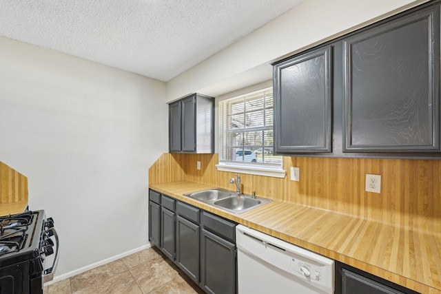 kitchen with dishwasher, gas range, light countertops, a textured ceiling, and a sink