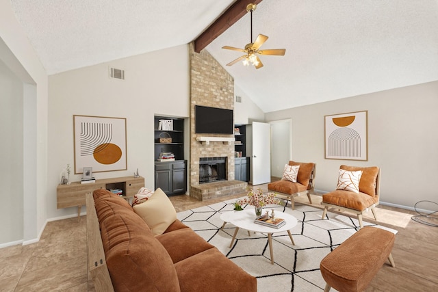 living room featuring visible vents, a ceiling fan, beamed ceiling, a textured ceiling, and a brick fireplace