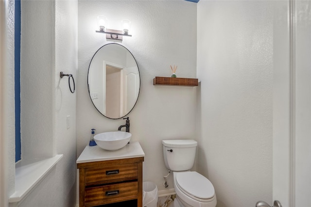 bathroom with toilet and vanity