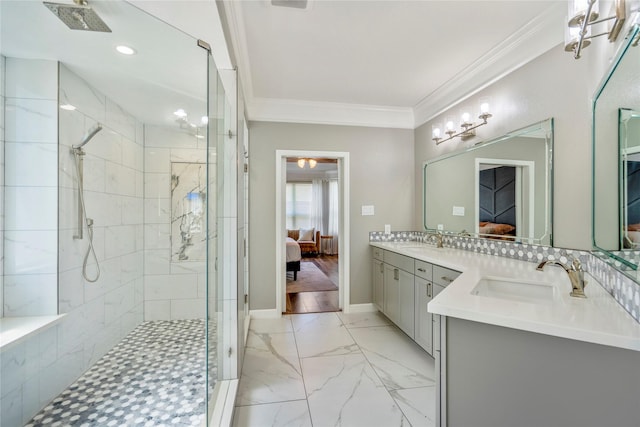 ensuite bathroom with a stall shower, a sink, ensuite bathroom, crown molding, and marble finish floor