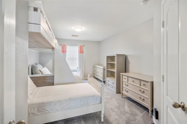 bedroom with visible vents and light colored carpet