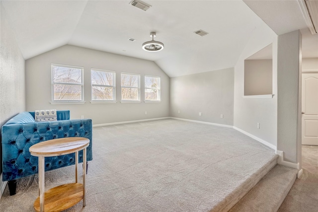 living area featuring visible vents, lofted ceiling, and carpet flooring