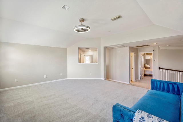 unfurnished living room with vaulted ceiling, carpet, visible vents, and baseboards