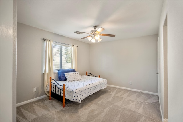 bedroom featuring visible vents, light colored carpet, baseboards, and ceiling fan