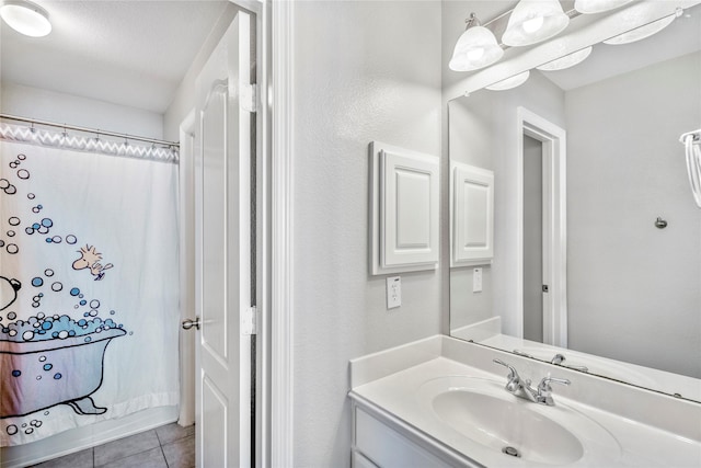 full bath featuring tile patterned floors, vanity, and a shower with curtain