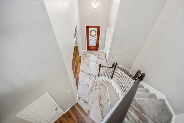 stairs with baseboards and marble finish floor