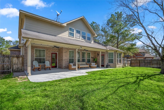 rear view of house featuring a fenced backyard, brick siding, ceiling fan, and a patio area