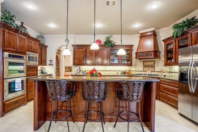 kitchen with a center island, crown molding, stainless steel appliances, custom range hood, and visible vents