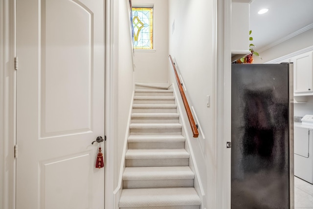 staircase with crown molding, independent washer and dryer, and recessed lighting