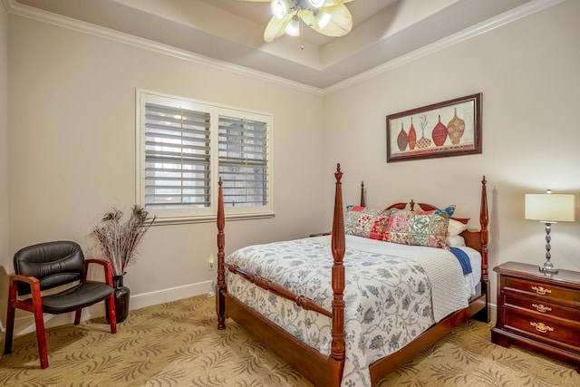 bedroom featuring ceiling fan, baseboards, carpet, a raised ceiling, and crown molding