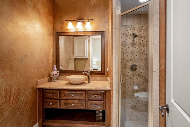 bathroom with a shower stall and vanity