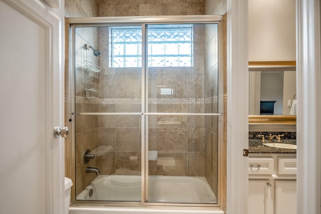 bathroom with toilet, bath / shower combo with glass door, and vanity