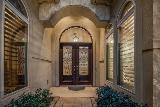 entrance to property with french doors and stucco siding