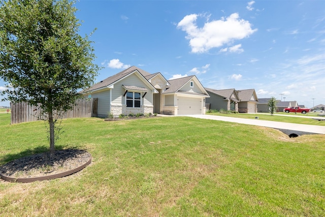 view of front of house with an attached garage, fence, concrete driveway, stone siding, and a front yard