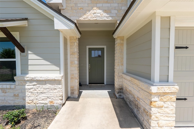 property entrance featuring stone siding