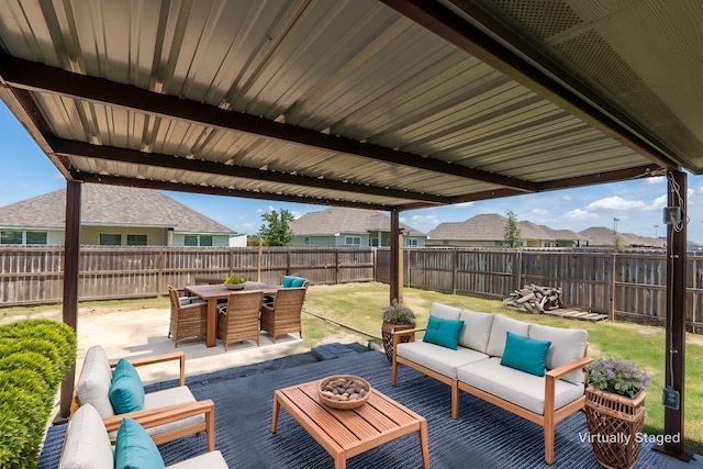 view of patio / terrace featuring a fenced backyard, outdoor dining area, and an outdoor living space with a fire pit