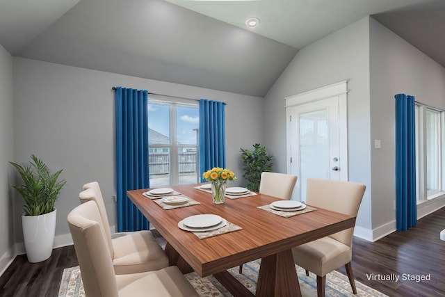 dining area with lofted ceiling, baseboards, and wood finished floors