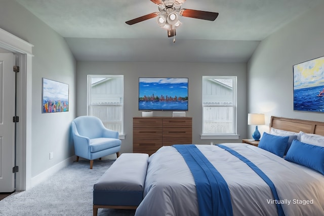 bedroom with carpet, vaulted ceiling, baseboards, and ceiling fan