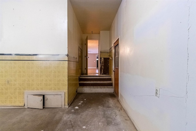 hallway featuring unfinished concrete floors