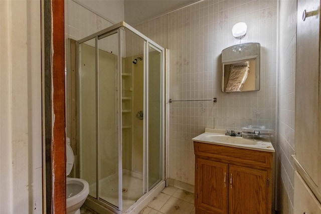 bathroom with a stall shower, tile patterned flooring, tile walls, and toilet