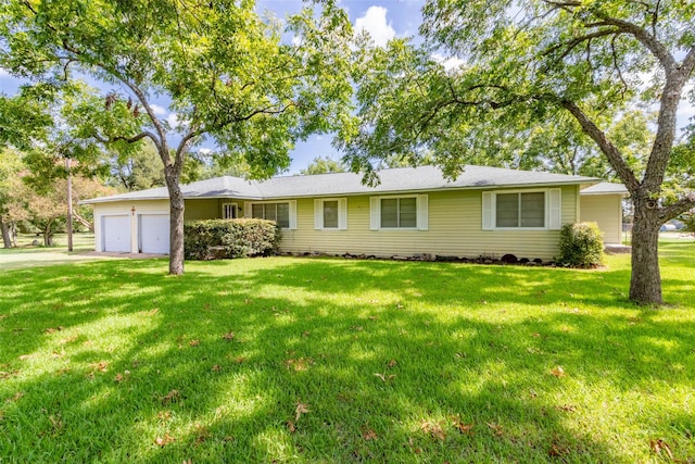 single story home featuring a garage and a front lawn