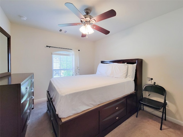 carpeted bedroom featuring visible vents, ceiling fan, and baseboards