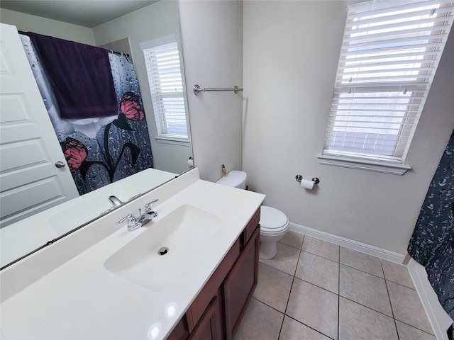 bathroom featuring toilet, tile patterned flooring, baseboards, and vanity