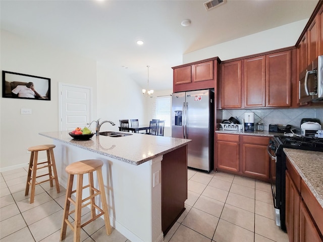 kitchen with light tile patterned floors, tasteful backsplash, visible vents, appliances with stainless steel finishes, and a sink