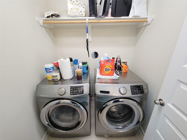 clothes washing area with laundry area and washer and clothes dryer