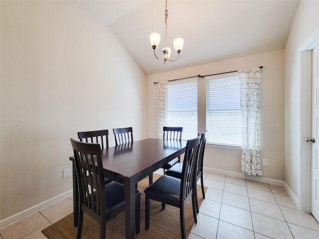 dining room with lofted ceiling, light tile patterned floors, baseboards, and an inviting chandelier