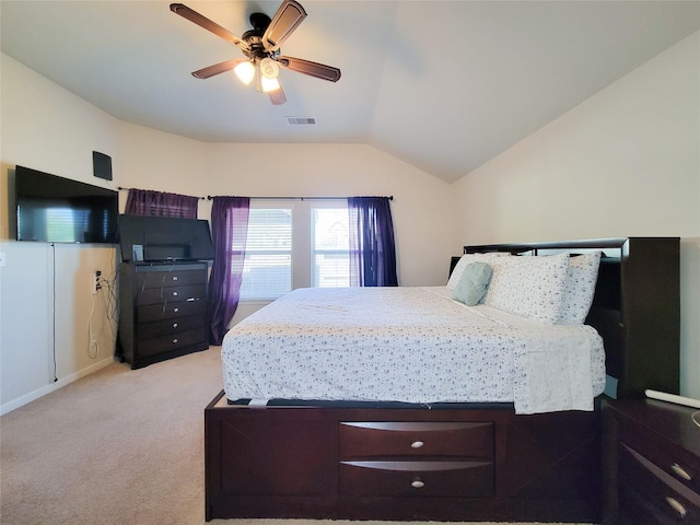 bedroom featuring light carpet, ceiling fan, visible vents, and vaulted ceiling