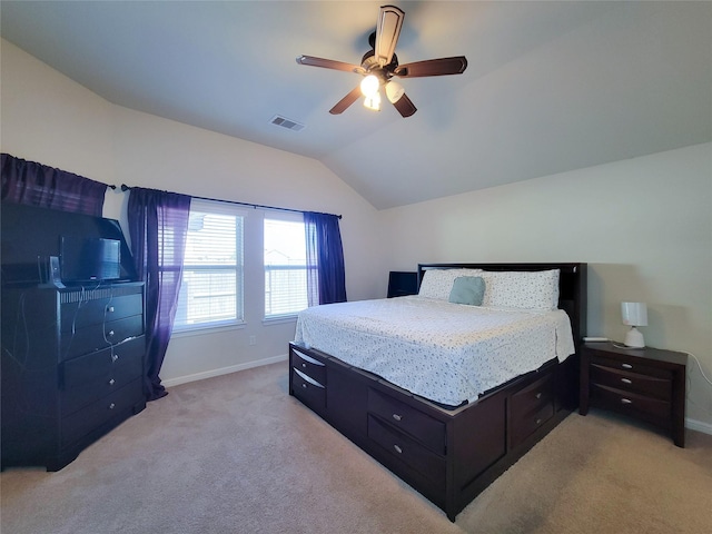 bedroom featuring visible vents, vaulted ceiling, light carpet, and baseboards