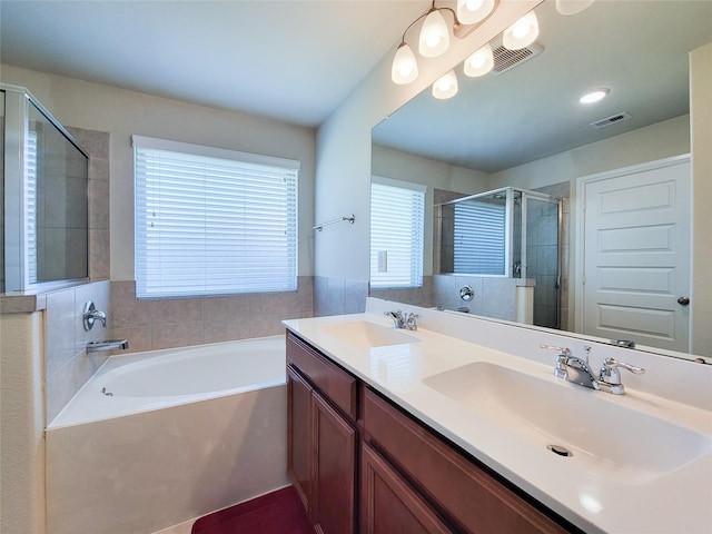 bathroom with a stall shower, visible vents, a sink, and a bath