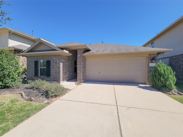 ranch-style house featuring a garage, driveway, and brick siding