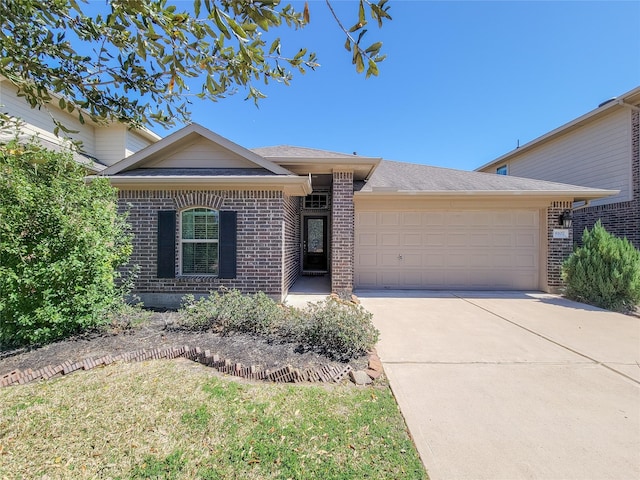 ranch-style house with driveway, brick siding, and an attached garage