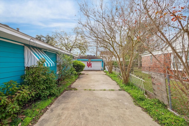 view of yard with fence and an outbuilding