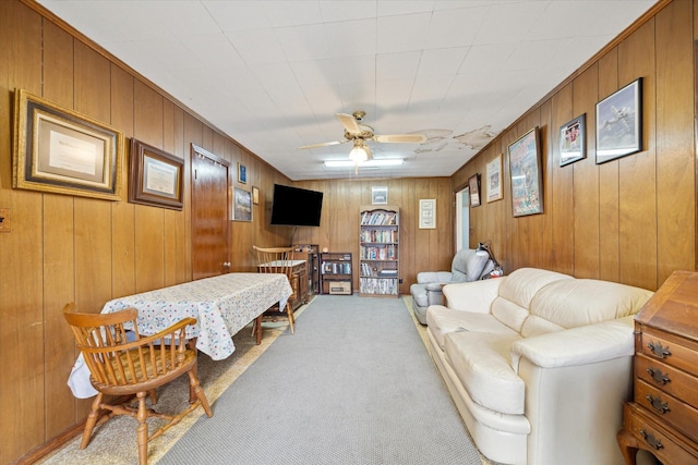 carpeted living room with ceiling fan