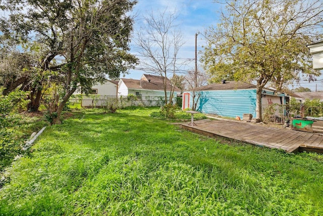 view of yard featuring fence and a wooden deck