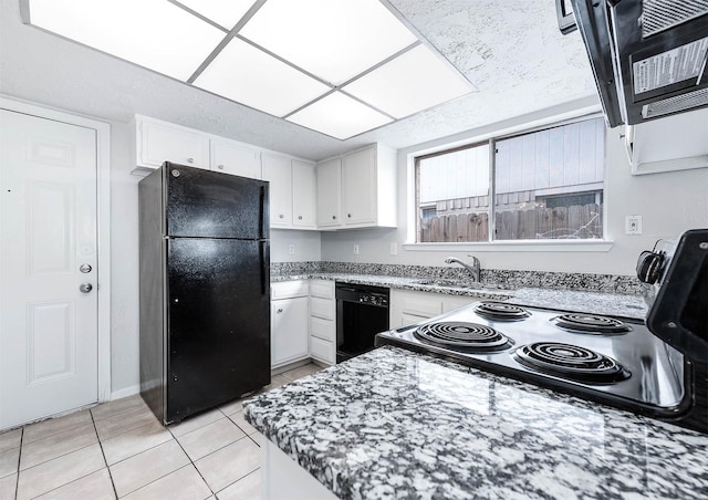 kitchen with light tile patterned floors, a sink, white cabinets, light stone countertops, and black appliances