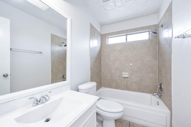 bathroom with a textured ceiling, tile patterned flooring, bathtub / shower combination, toilet, and vanity