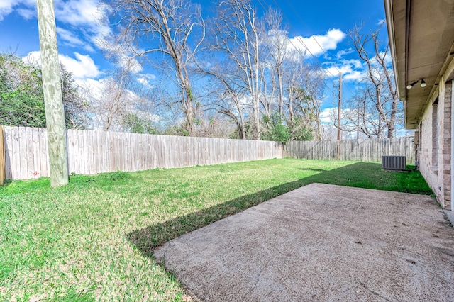 view of yard with a patio area, a fenced backyard, and central AC unit