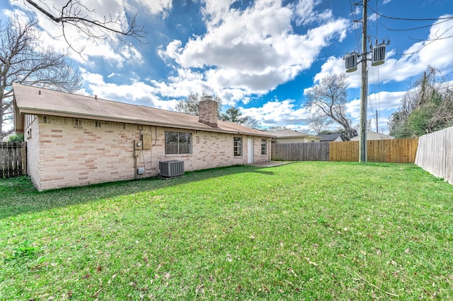 view of yard with a fenced backyard and cooling unit