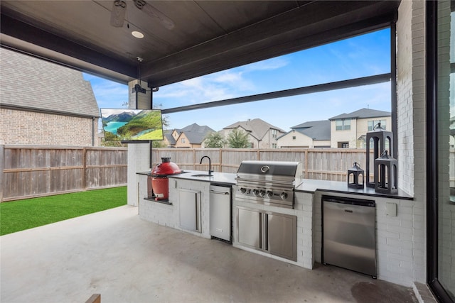 view of patio featuring ceiling fan, a fenced backyard, area for grilling, a sink, and exterior kitchen